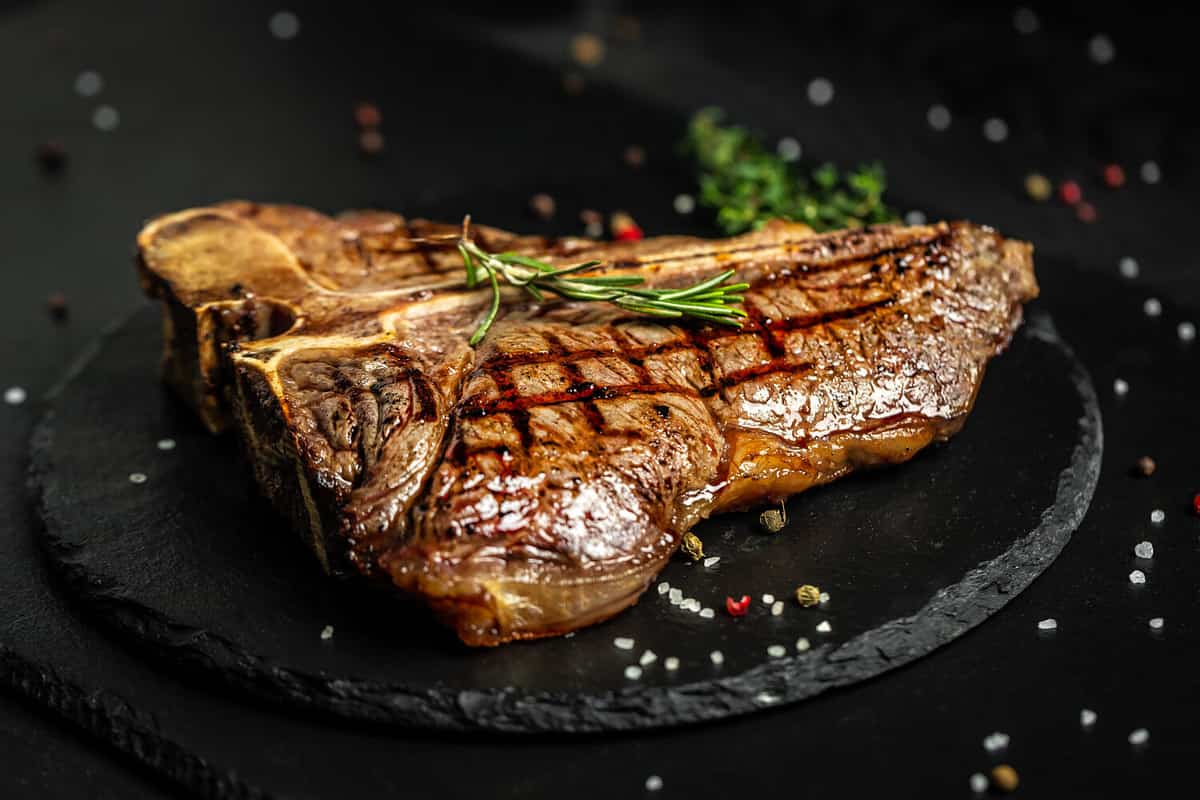 T-bone or aged wagyu porterhouse grilled beef steak with spices and herbs. Medium rare Grilled T-Bone Steak, Barbecue aged wagyu porterhouse