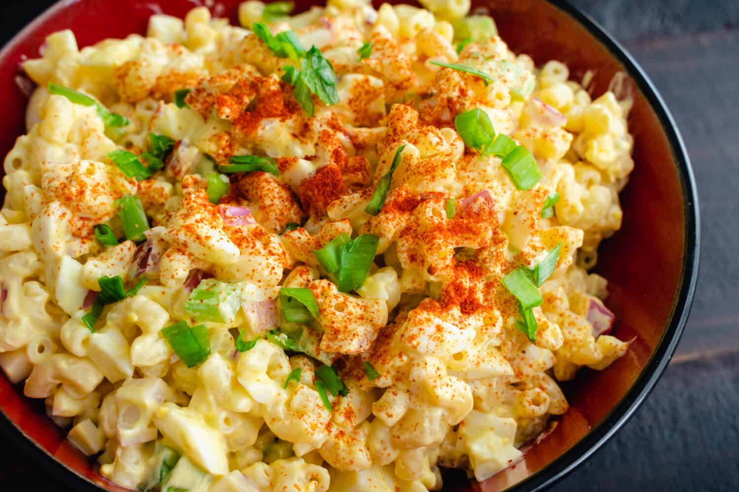 Deviled Egg Pasta Salad in a Serving Bowl: A large bowl of macaroni salad made with hard-boiled eggs