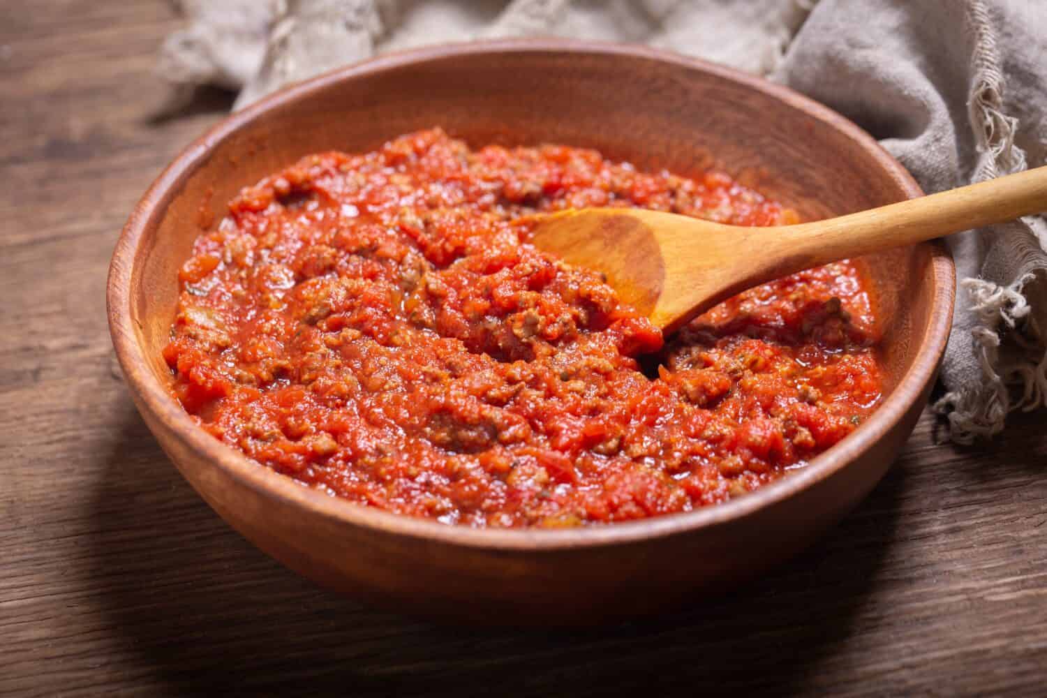 bowl of meat sauce bolognese on a wooden table