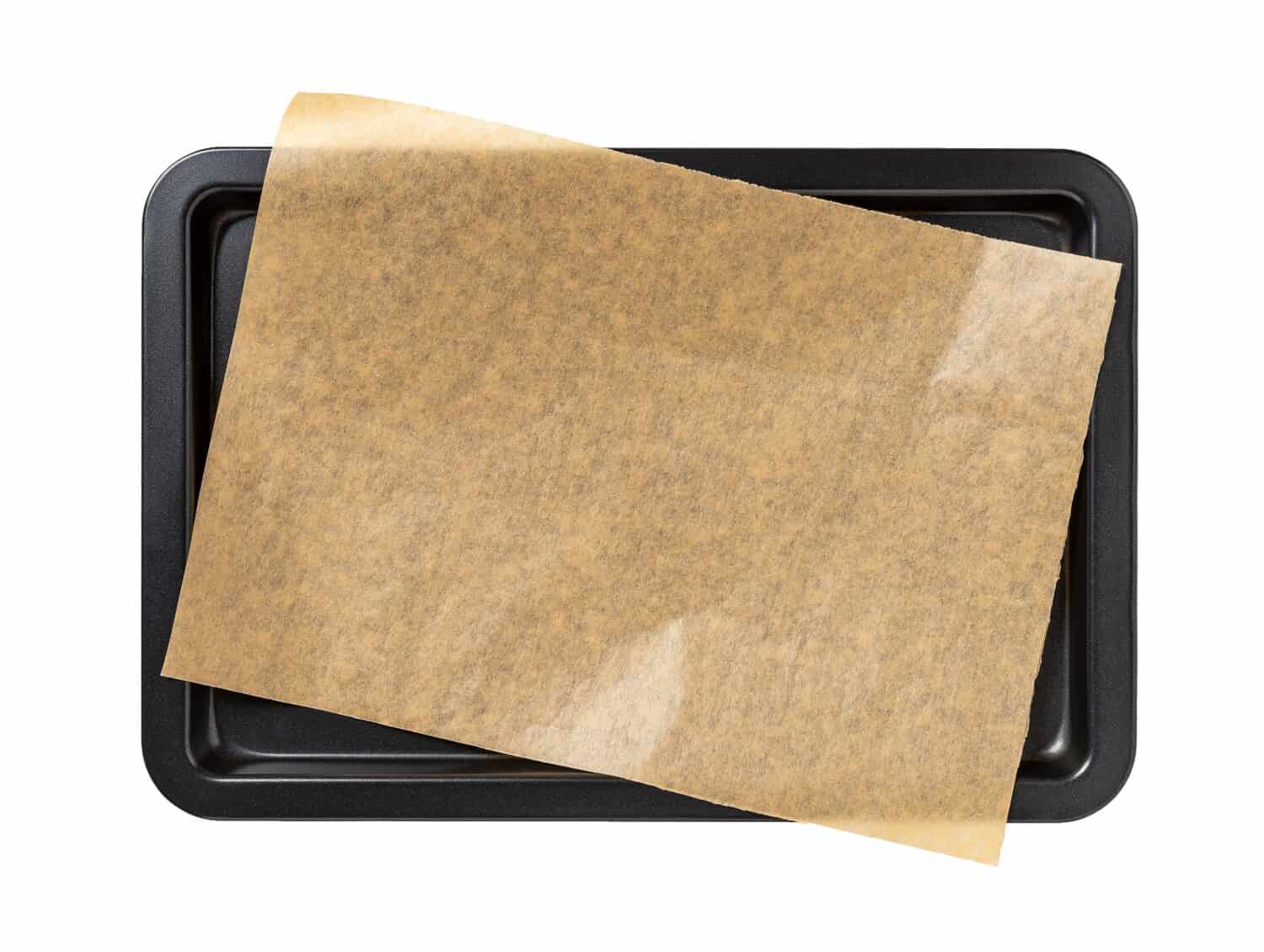 rectangular metal baking sheet and roll of brown parchment paper