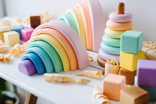 Children's wooden toys. Rainbow made of natural wood. Colorful Cubes and pyramid. Montessori toys. Eco-friendly, plastic free toys for kids. Zero waste concept.