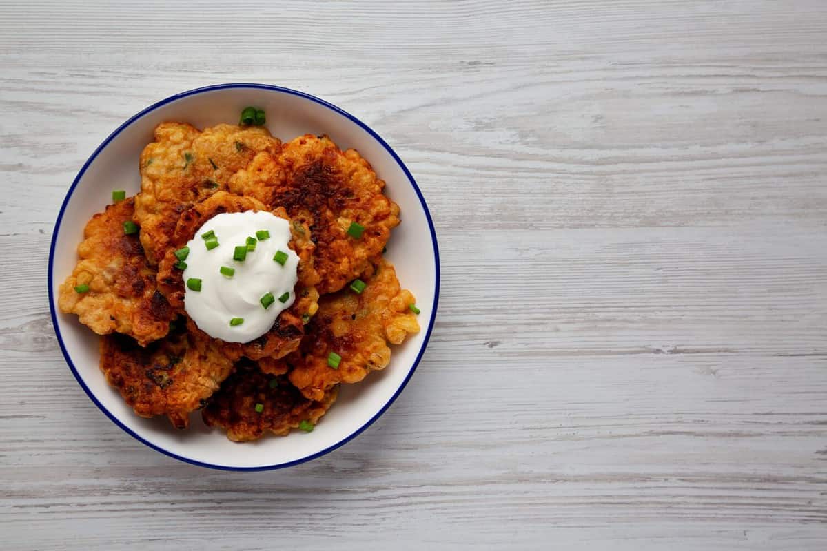 Homemade Fried Cheddar Corn Fritters on a Plate, top view. Flat lay, overhead, from above. Copy space.