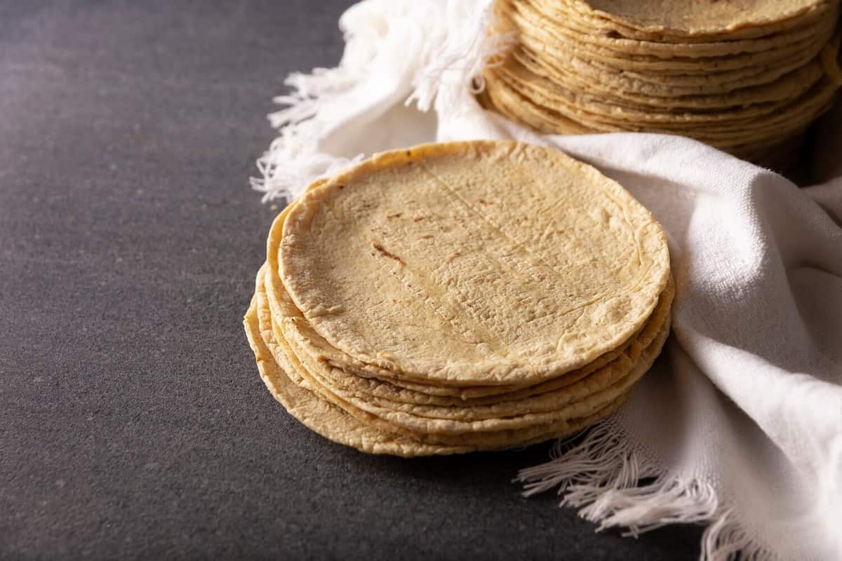 Corn Tortillas. Food made with nixtamalized corn, a staple food in several American countries, an essential element in many Latin American dishes.