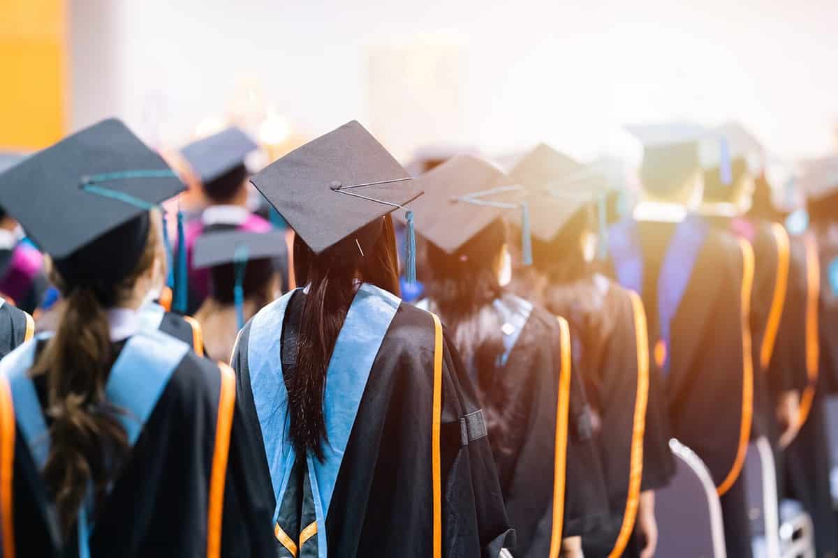 Graduates of the University of New Mexico, one of the oldest school in New Mexico, posing for a photo.