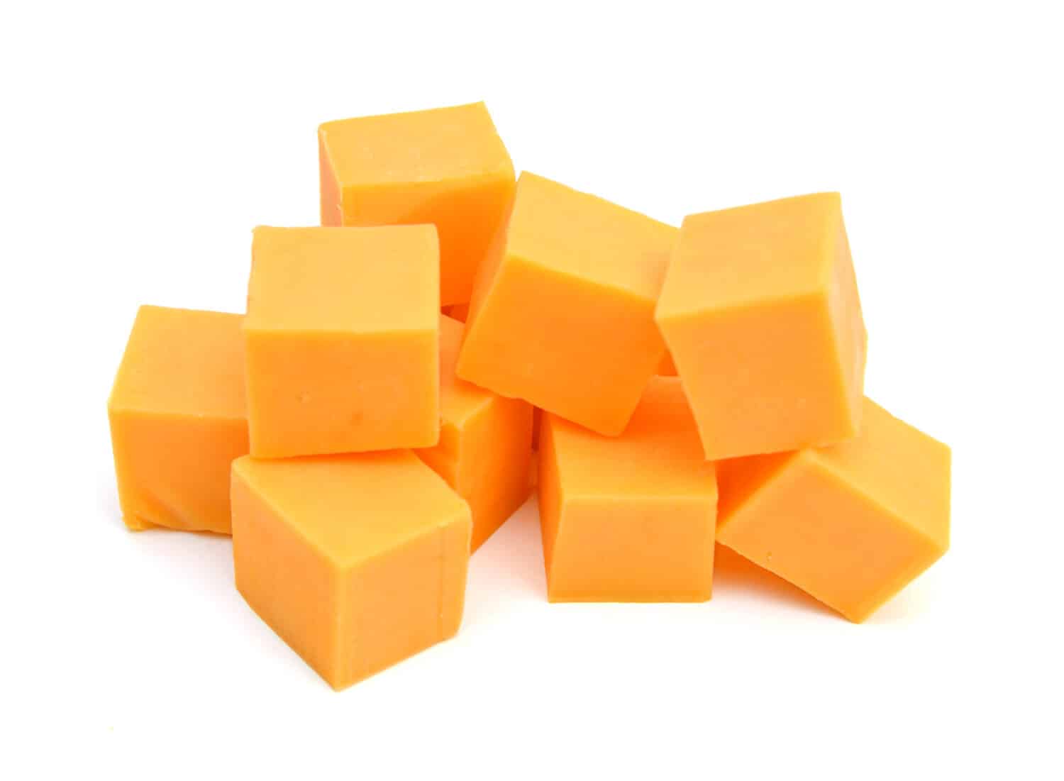 Cubes of cheddar cheese isolated on white 