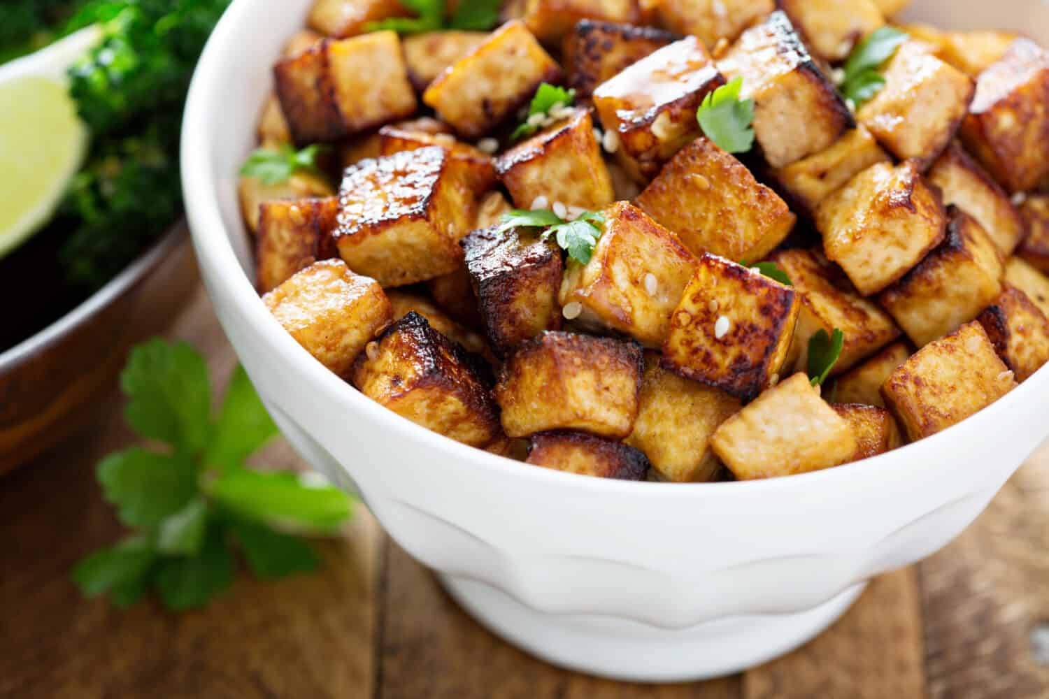 Stir fried tofu in a bowl with sesame and greens