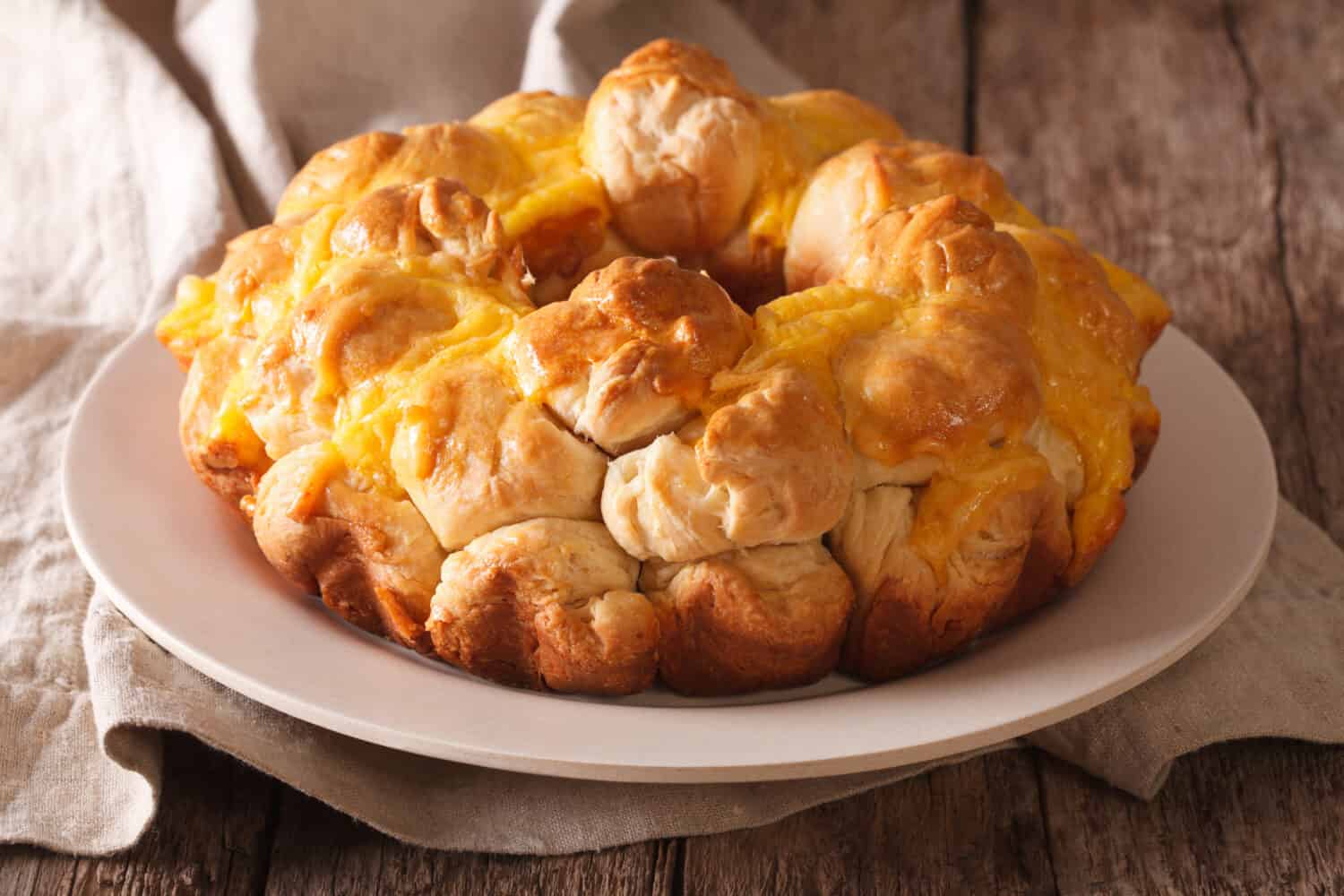 Delicious monkey bread with cheese close-up on a plate on the table. horizontal