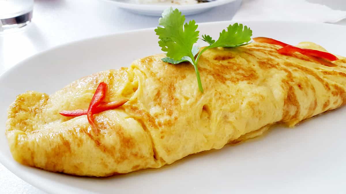 closeup of a plate with a typical tortilla de patatas, spanish omelet, on a set table