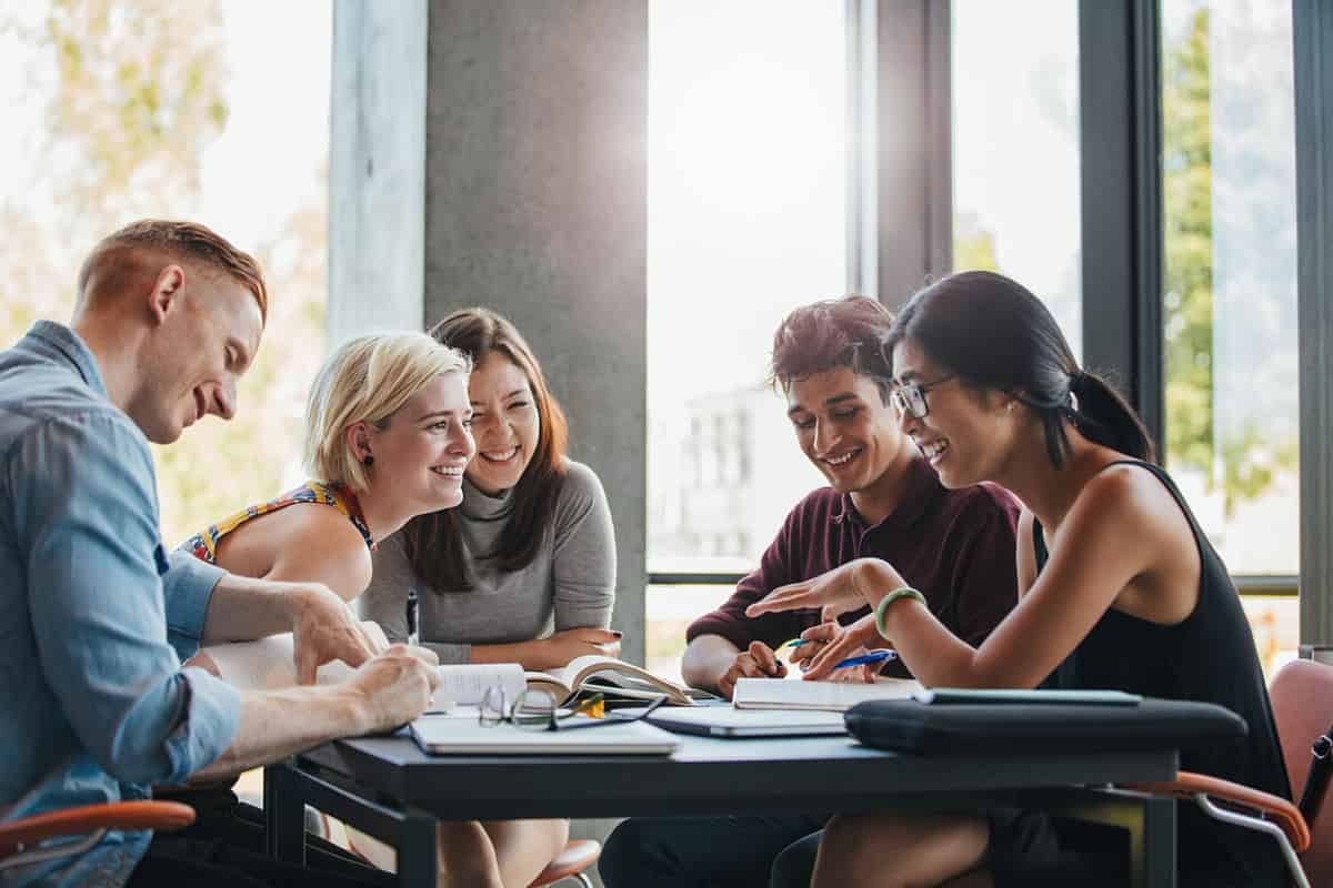 College kids seated at a table. 