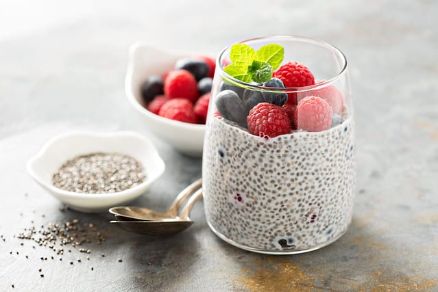 Healthy vanilla chia pudding in a glass with fresh berries