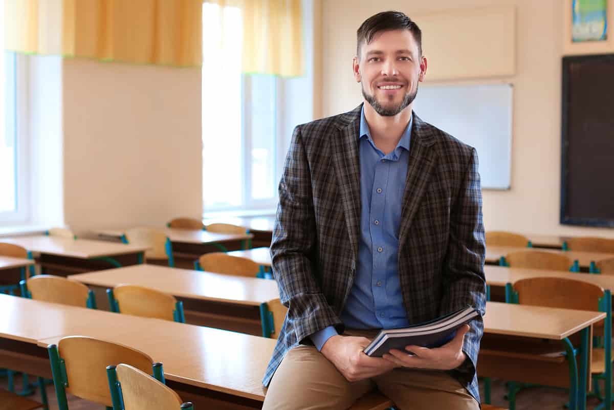 Portrait of happy teacher in classroom