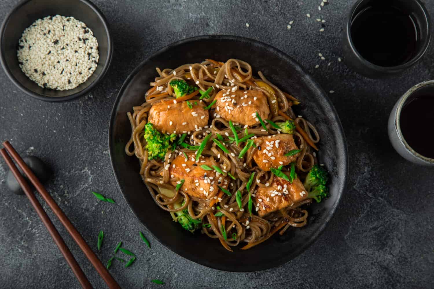 teriyaki salmon and soba noodle served with sesame seeds and chives, top view,