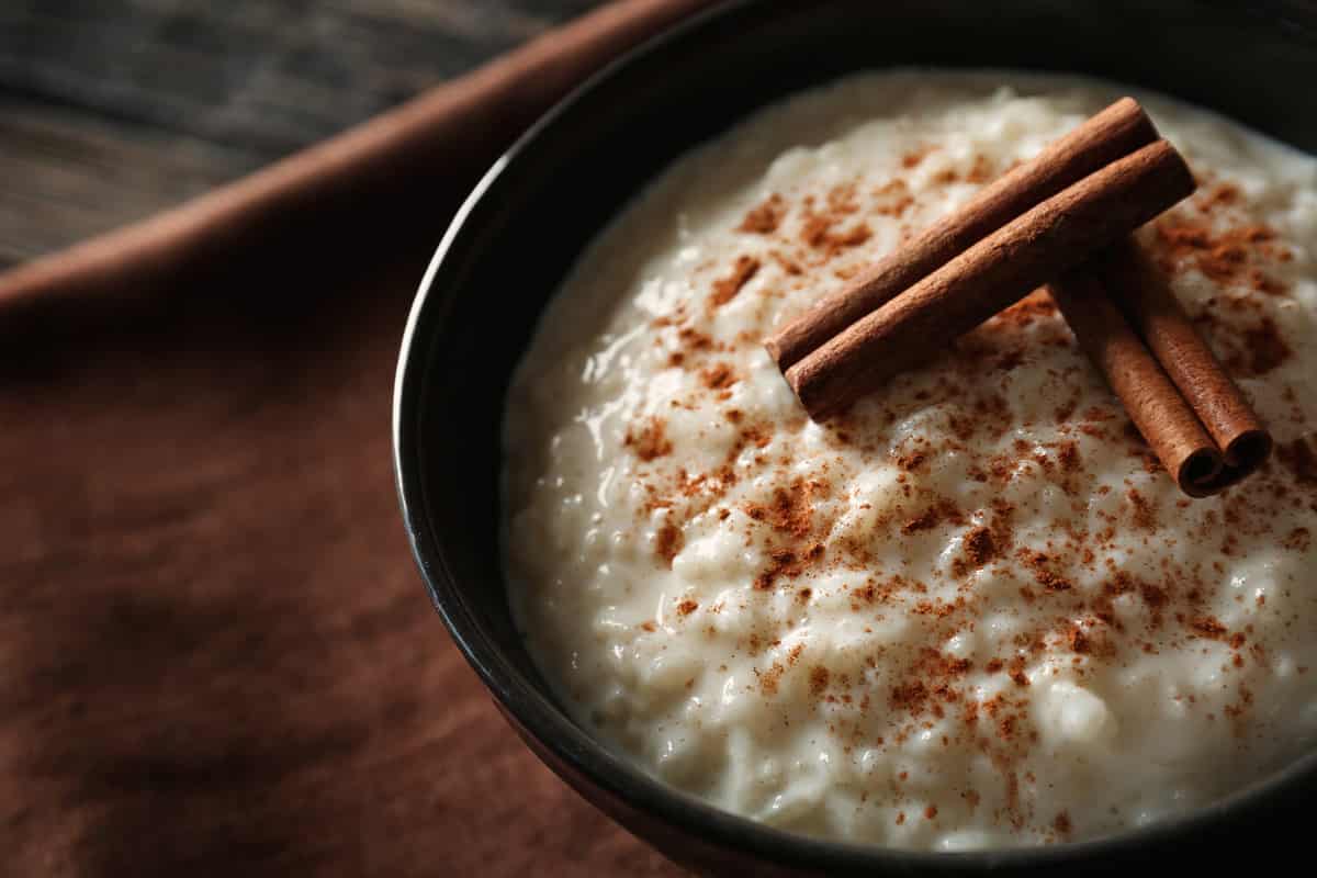 Delicious rice pudding with cinnamon in bowl, closeup