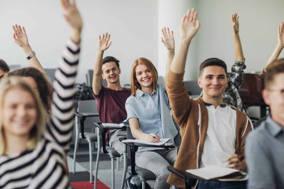 A photo of high school students in class actively participating in learning.