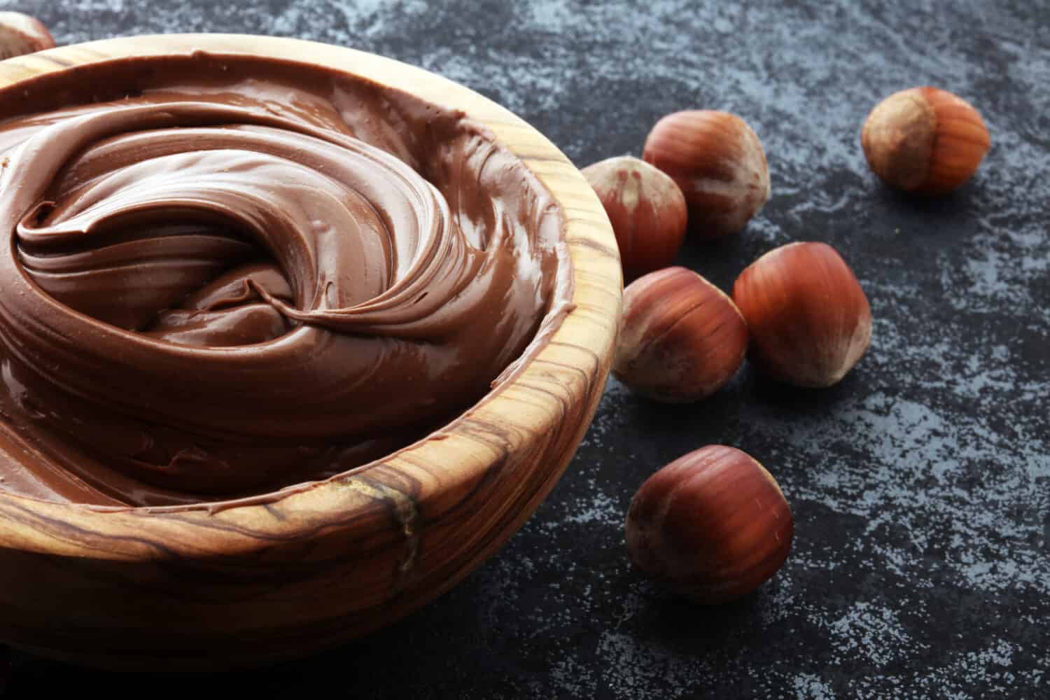 Homemade hazelnut spread in wooden bowl. Hazelnut Nougat cream.