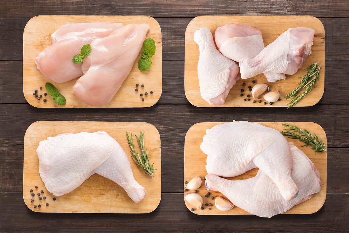 Different cuts of chicken displayed on cutting boards