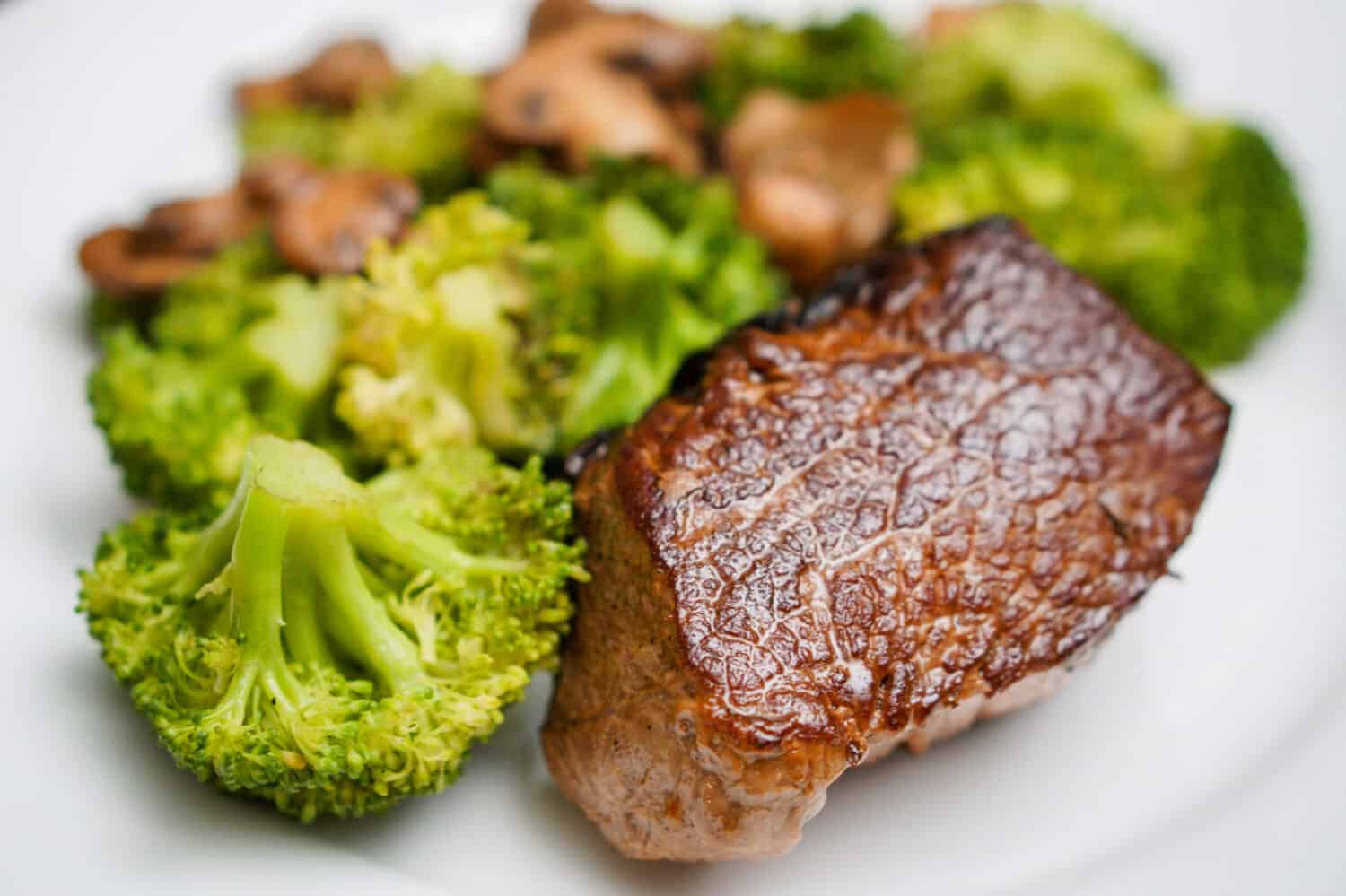 Top Sirloin Beef Steak Cooked Medium Rare Served with Steamed Broccoli