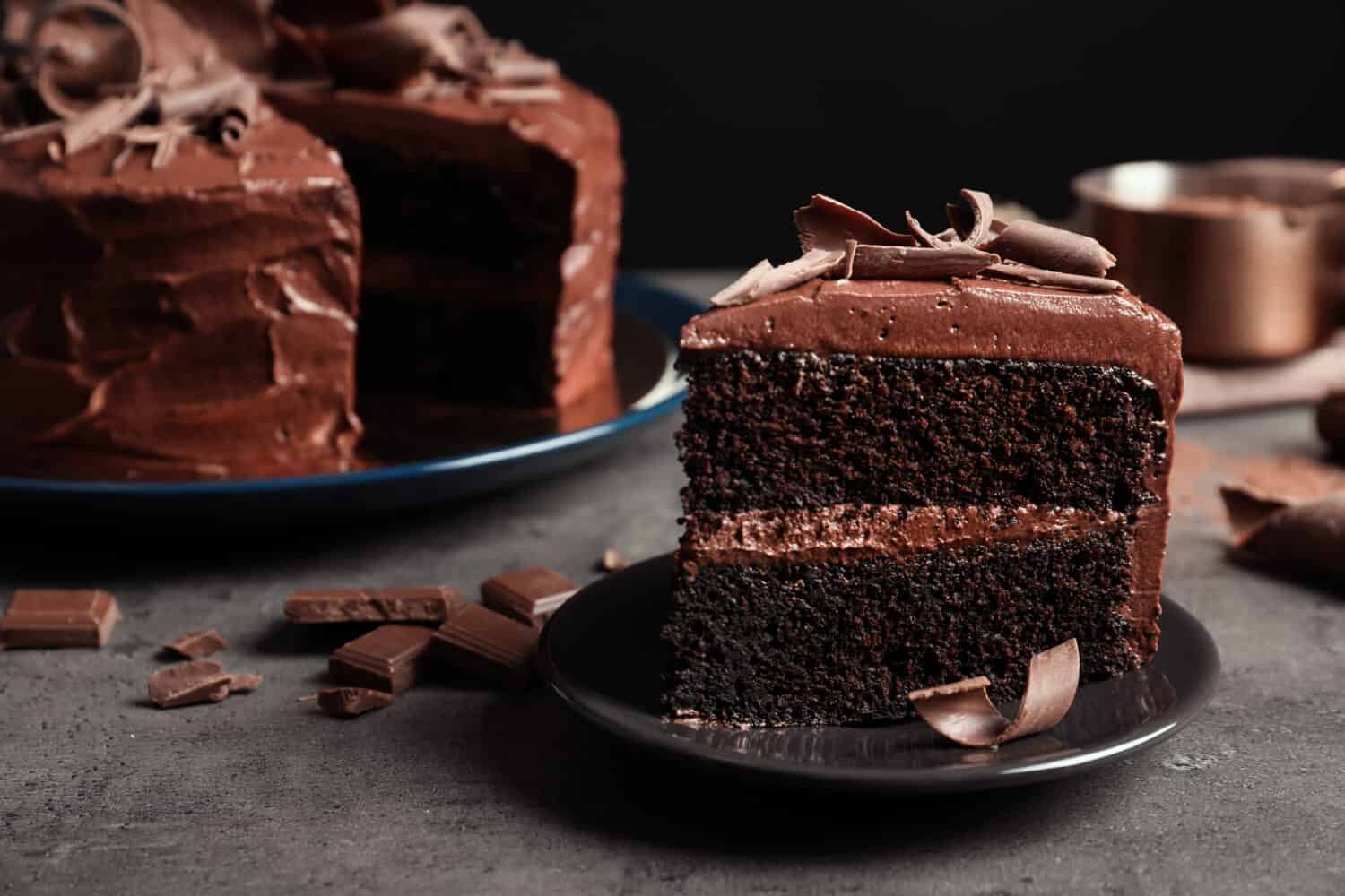 Plate with slice of tasty homemade chocolate cake made with cake flour on table