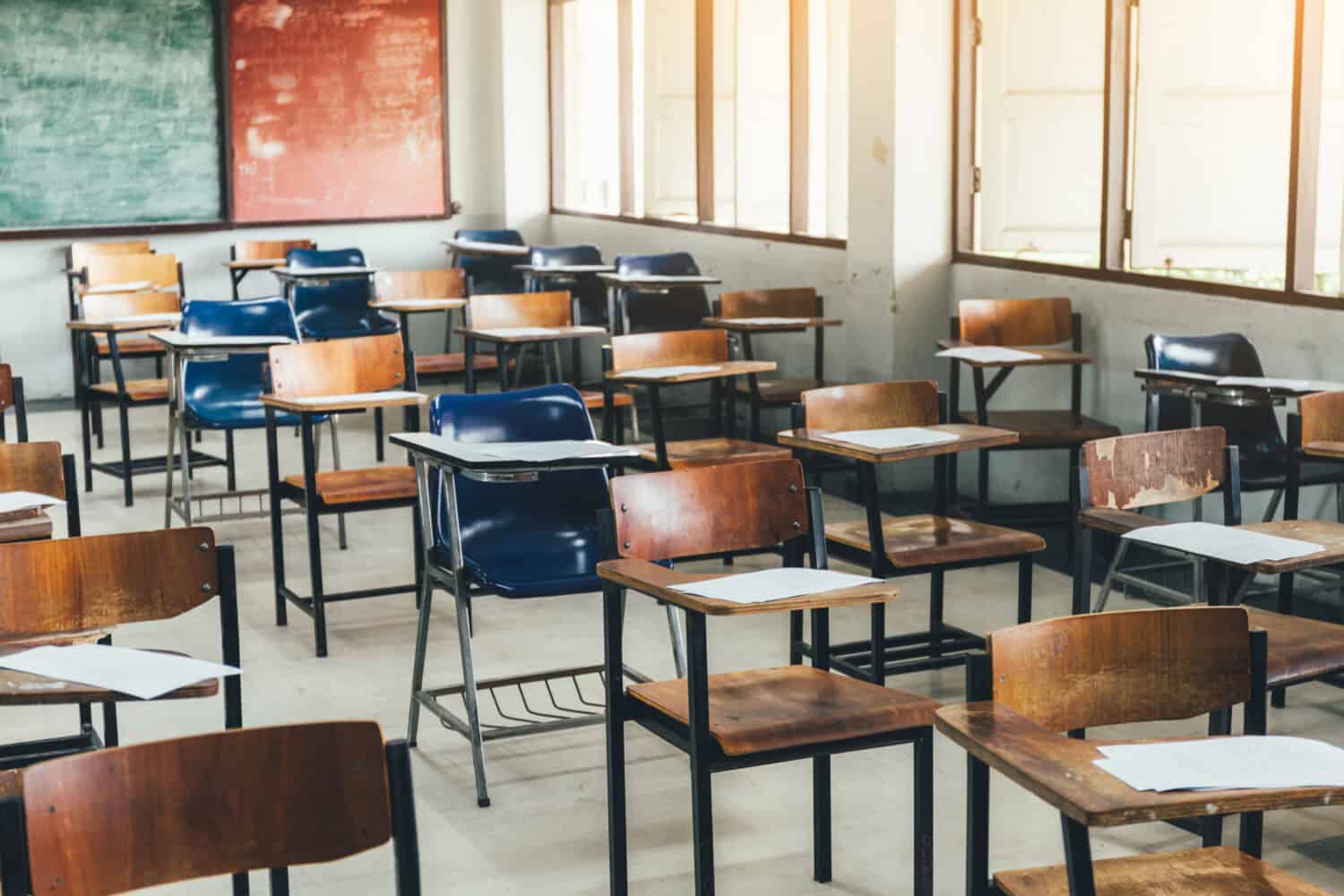 selective soft and blur focus.old wooden row lecture chairs in classroom in poor school.study room without student.concept for education