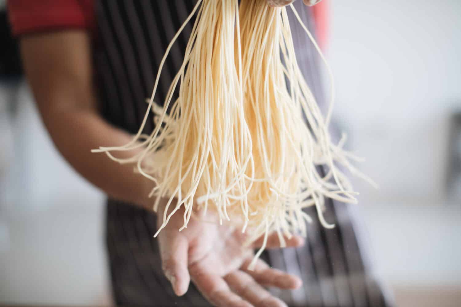 Making Handmade Noodles on wood background