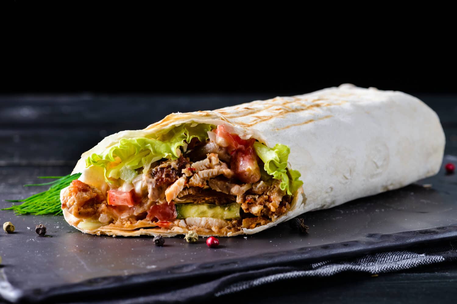 Traditional Mexican food, burritos with meat and beans, selective focus of beef steak burritos with vegetable