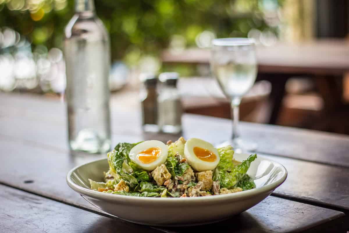 Classic Fresh Caesar Salad Cool crunchy cos lettuce, bacon, garlic croutons, chilled free range hard boiled egg, house-made Caesar dressing, parmesan cheese