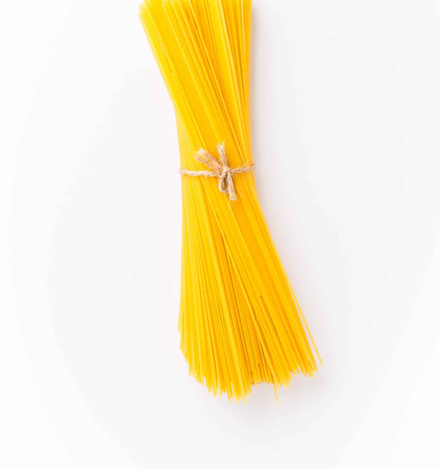 Spaghettini - thinner Spaghetti. Raw Spaghetti on white background.