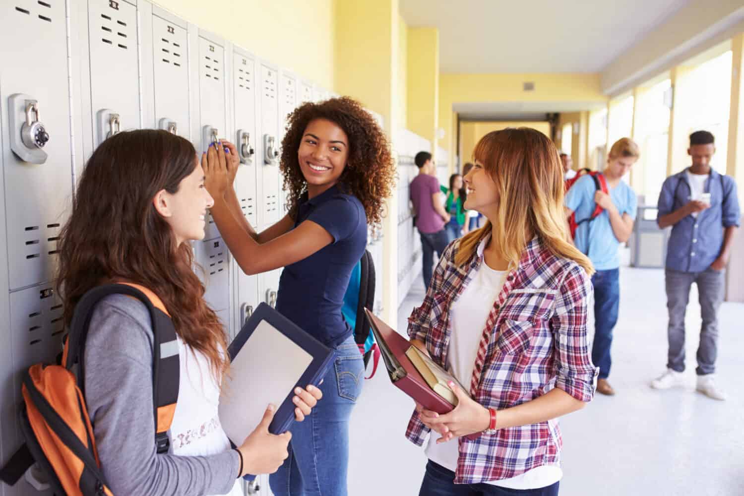 High school students chatting  in front of their lockers at Cathedral High School, Indianapolis