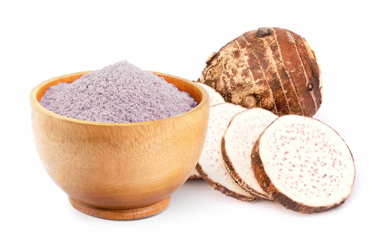 Fresh taro root and dreid powder isolated on white background.