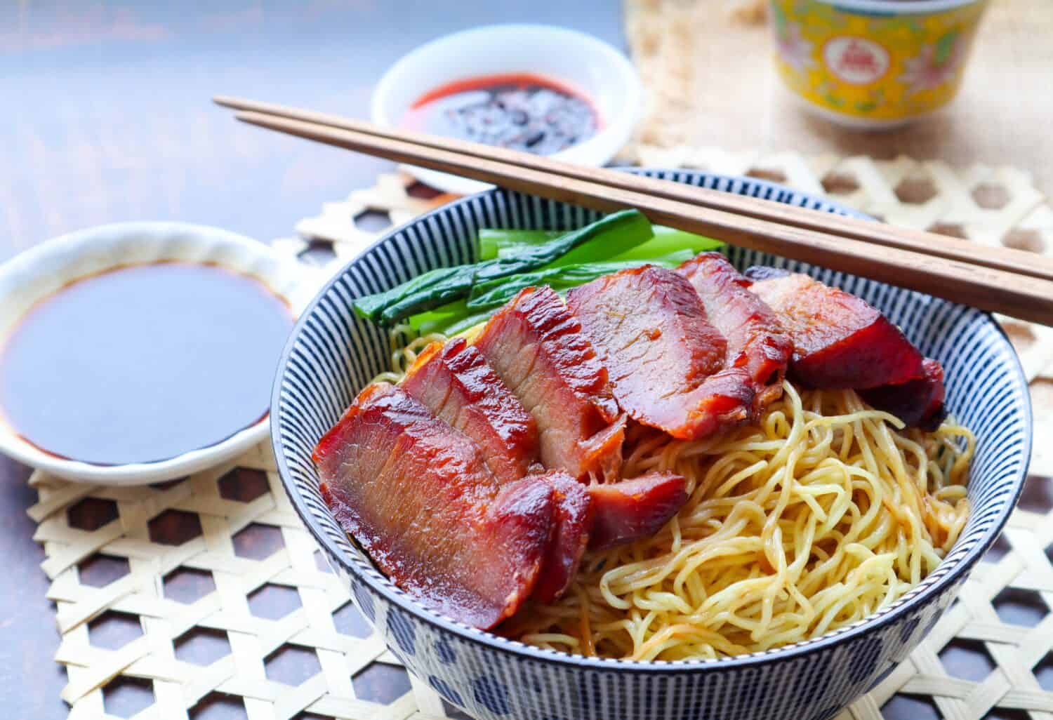 Chinese barbecue roast pork noodle (Char Siu) in a bowl - close up view of Asian food