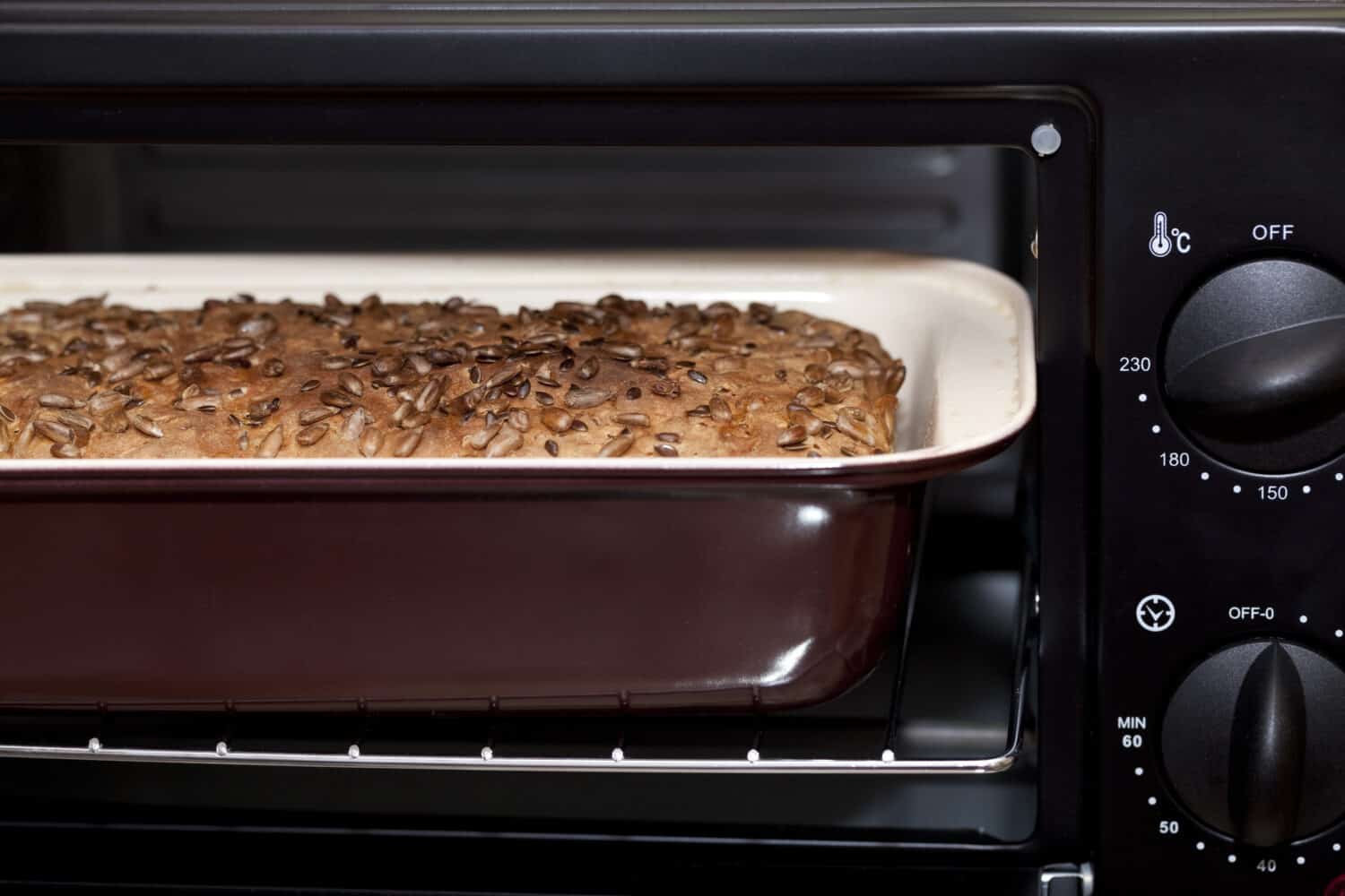 baked small bread with sunflower in oven