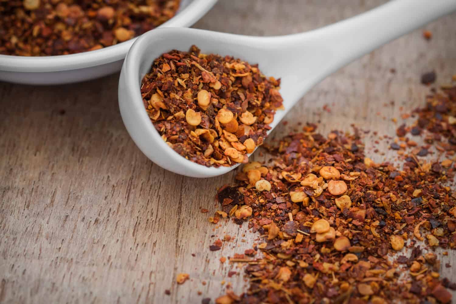 Chili flakes on wooden table