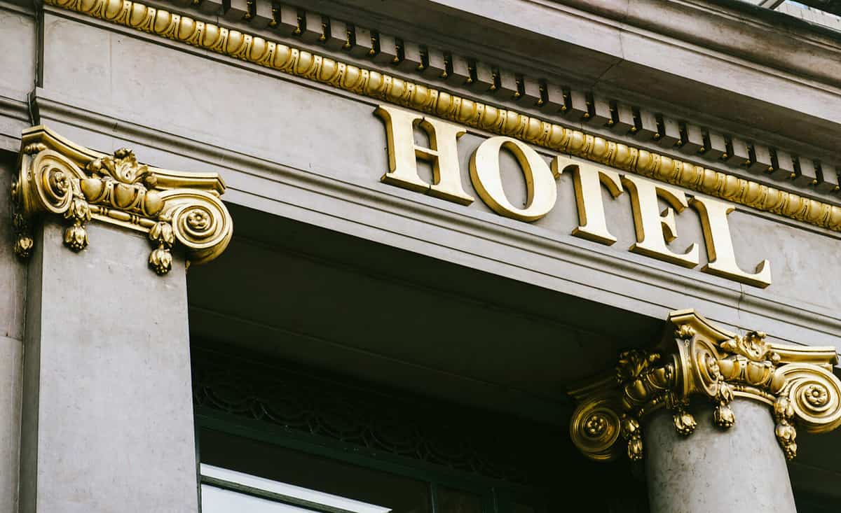 Hotel word with golden letters on luxury hotel with beautiful columns