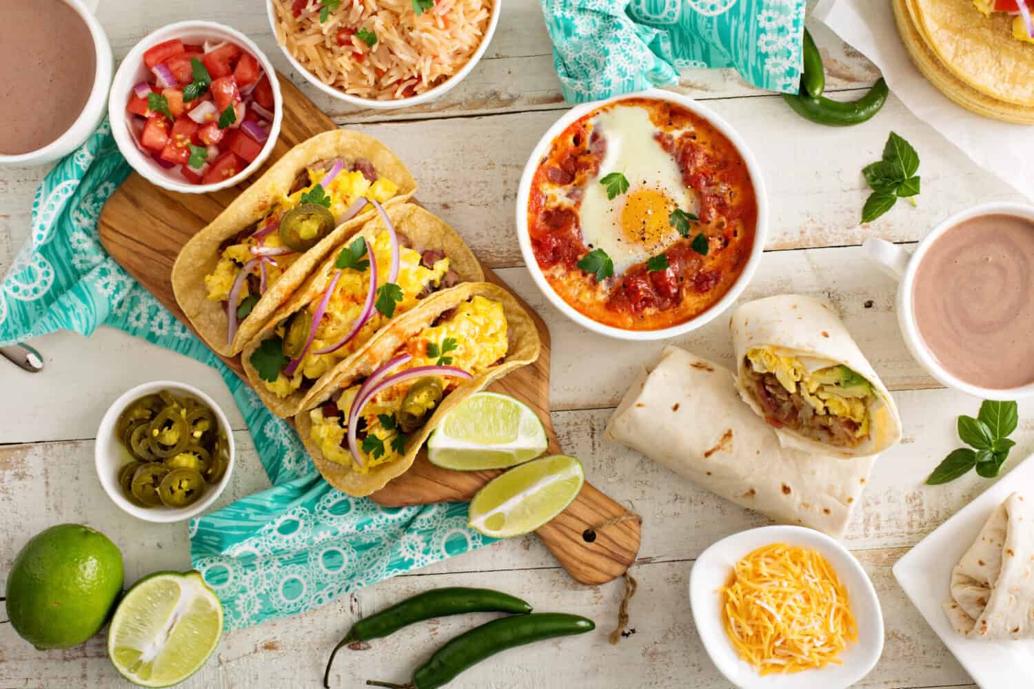 Tacos and burritos laid out with other classic Mexican fare.