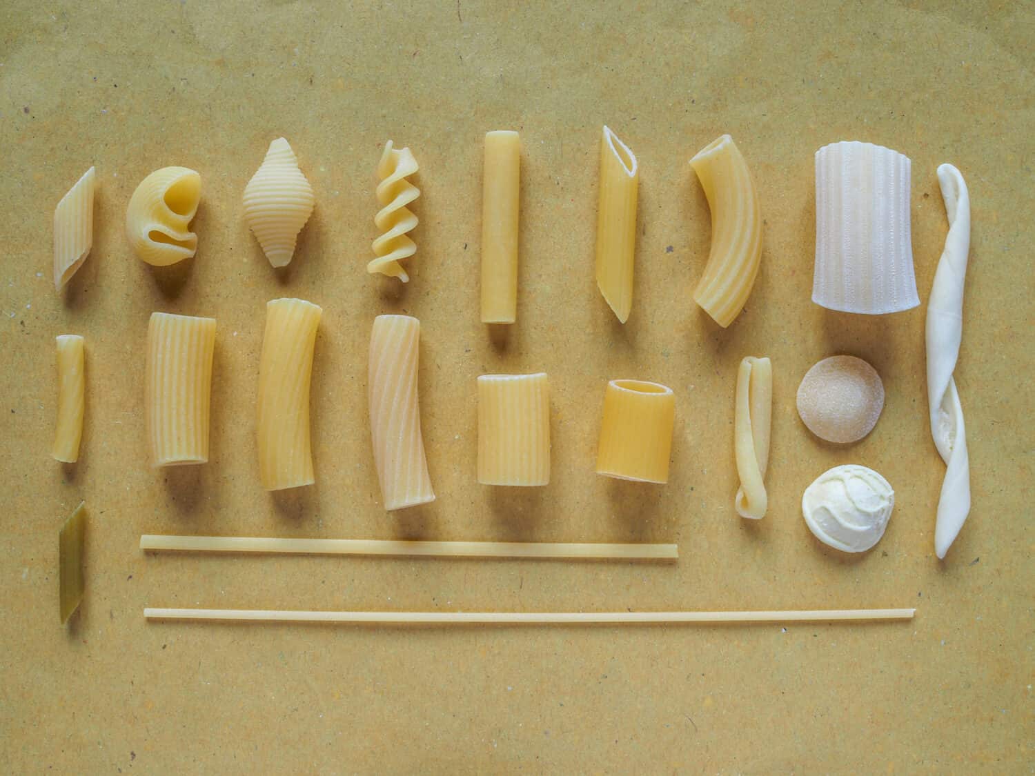 Many different types of Italian pasta including penne macaroni (maccheroni) fusilli spaghetti trenette (linguine) orecchiette tortiglioni conchiglie (shells)