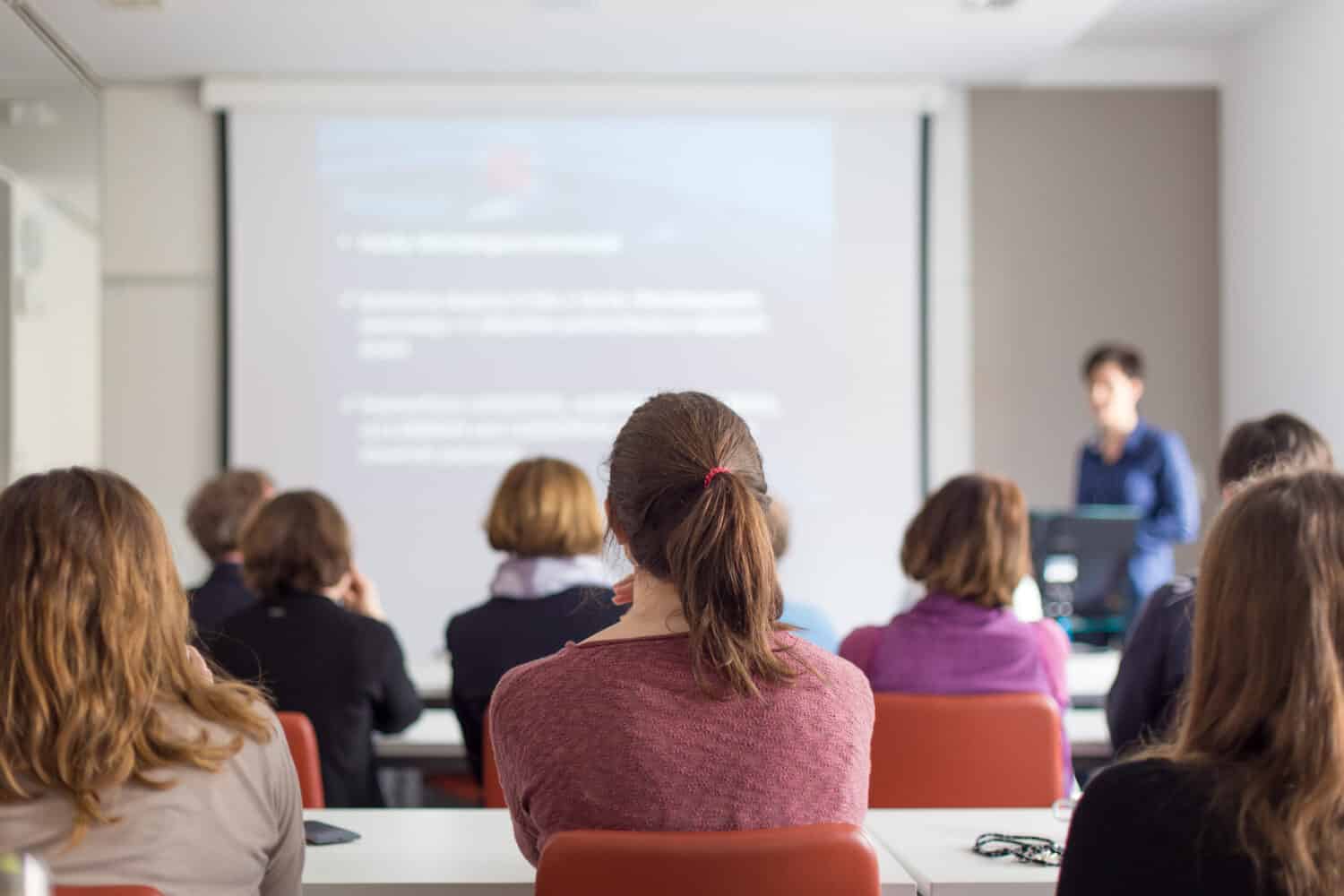 University students listening keenly listening to a professor.