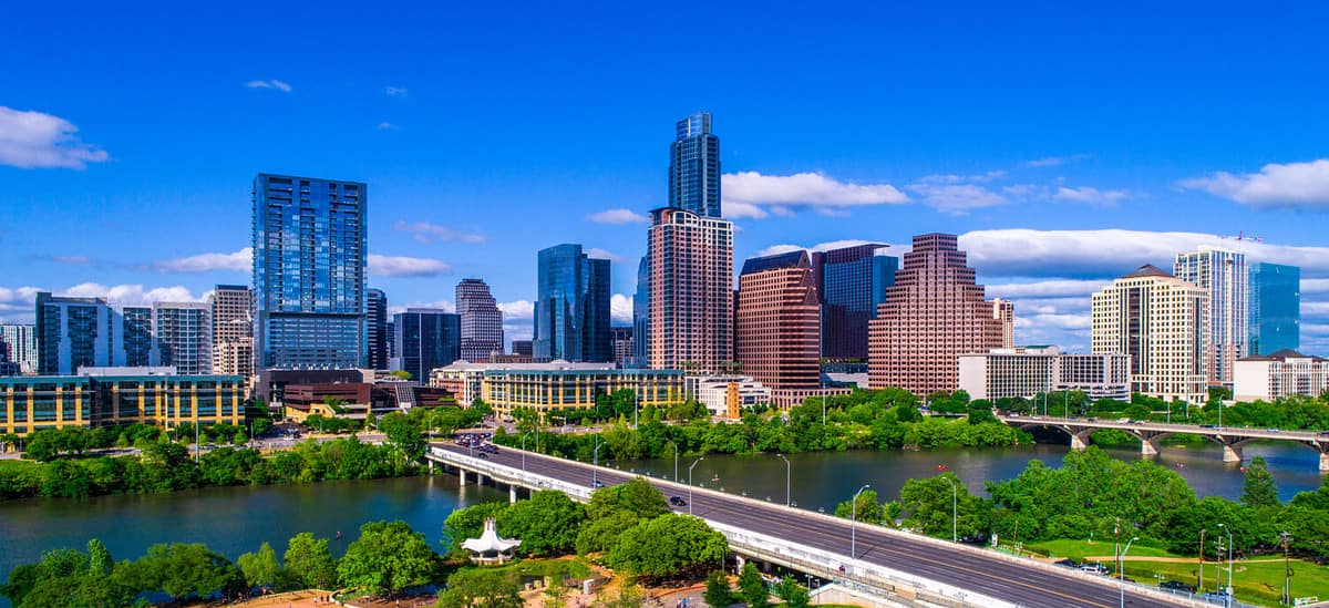 Austin Texas skyline during mid-day sunny summer perfect blue sky with entire city scape office buildings capital cities cityscape auditorium shores Panoramic