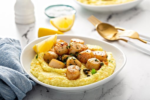 Seared scallops with grits and lemon sauce