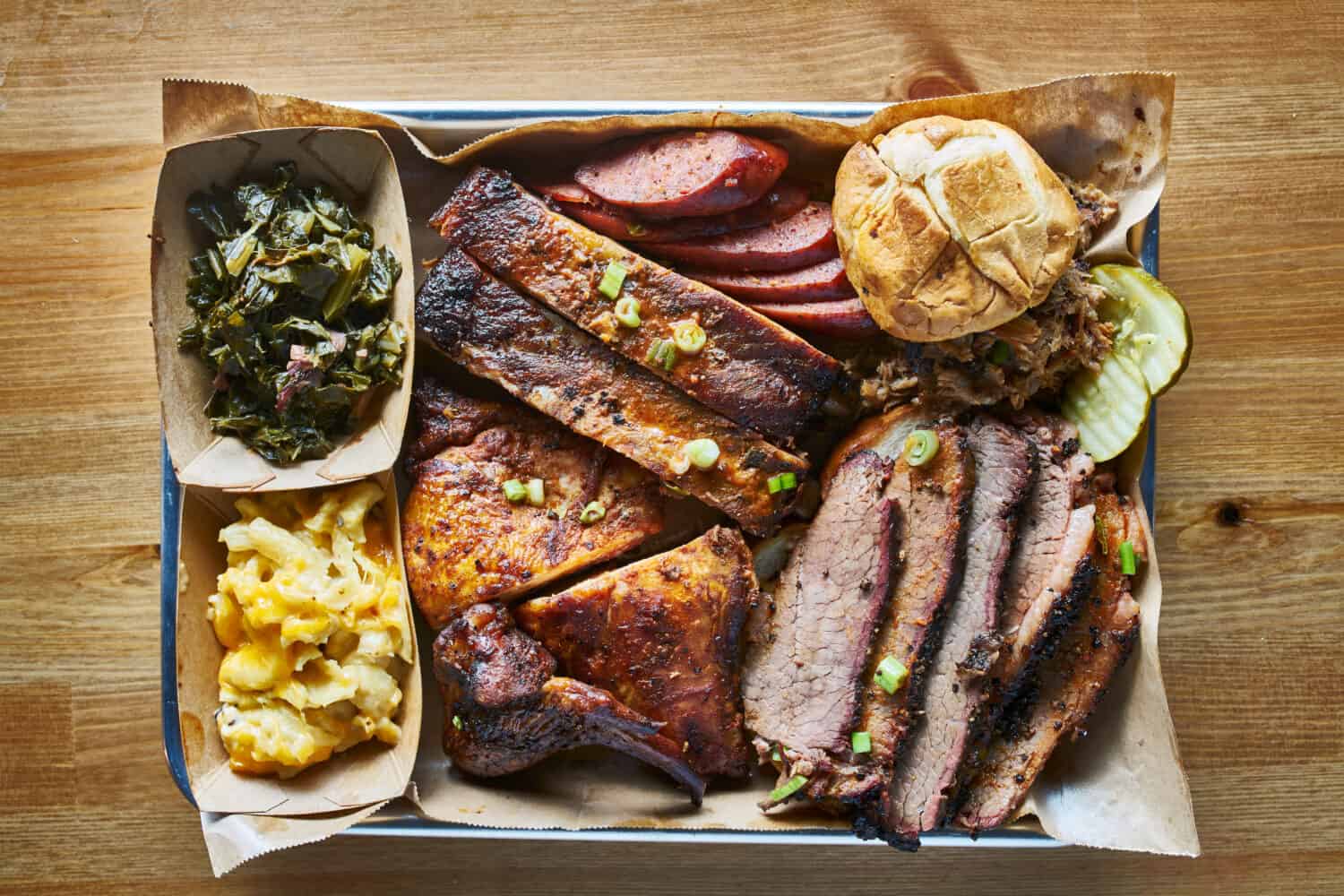 texas bbq style tray with smoked beef brisket, st louis ribs, chicken and hot links