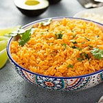 Mexican rice with tomatoes and onion served with cilantro