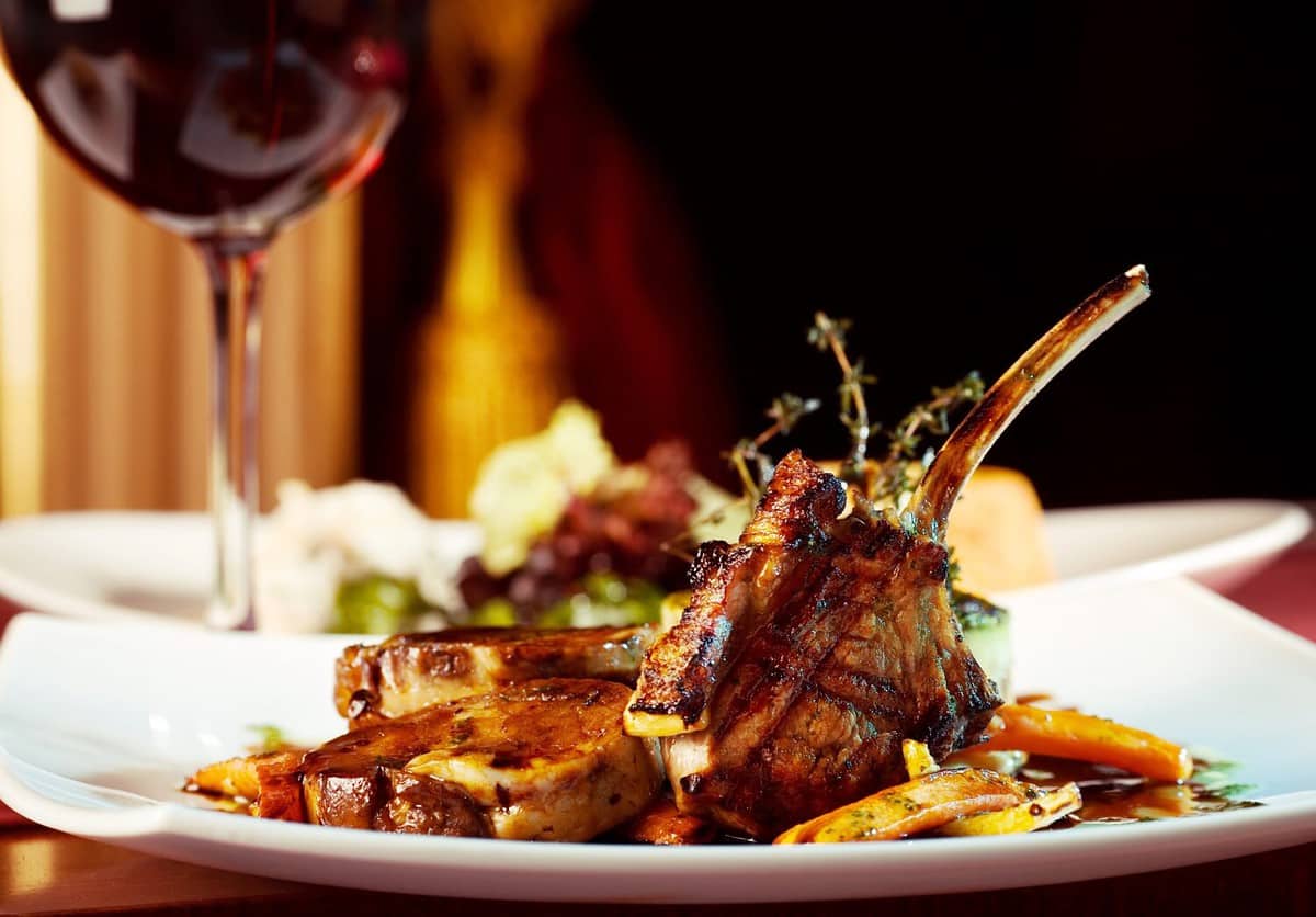 luxury dinner served on the table with glass of red wine