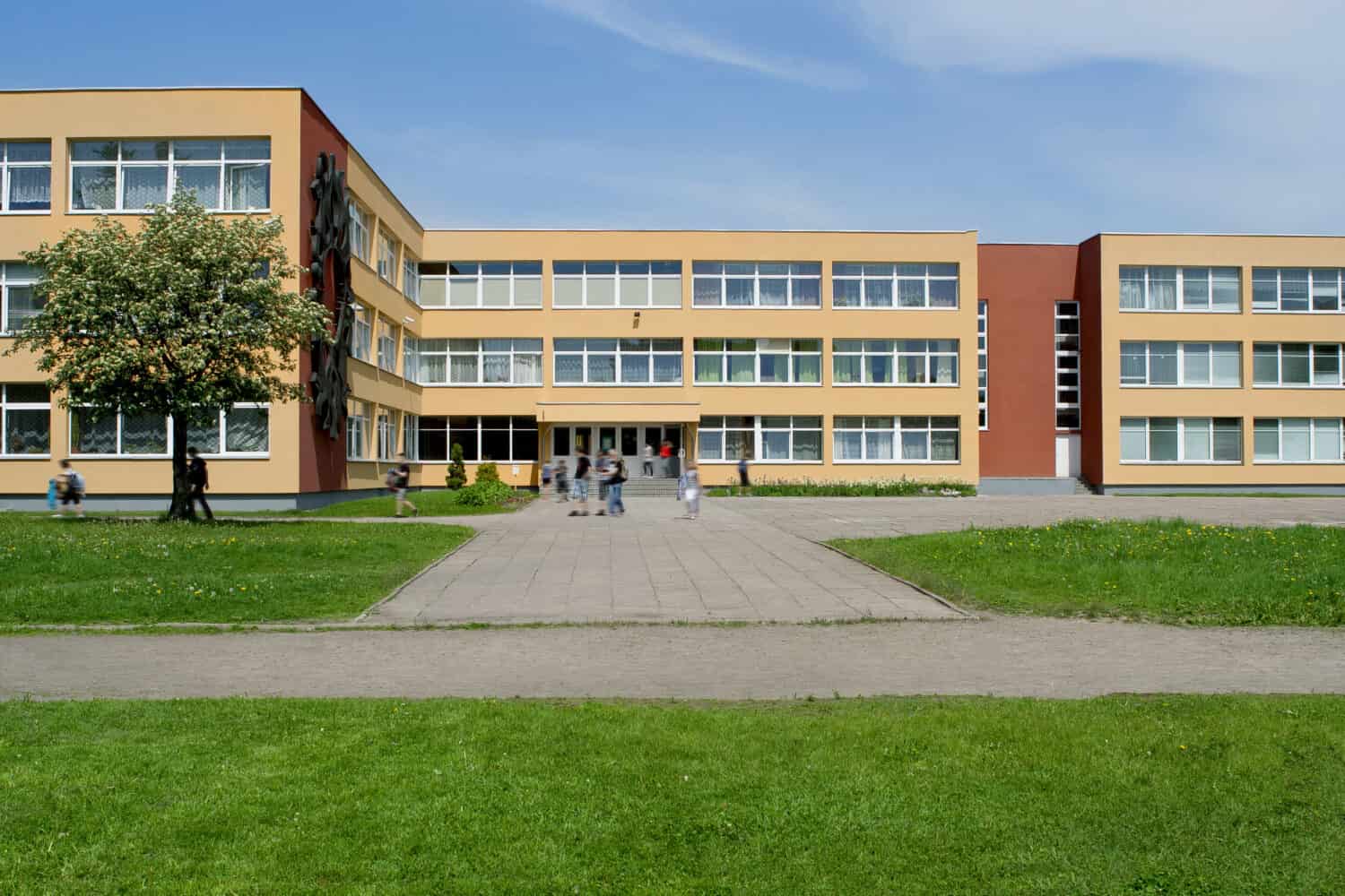 Public school building. Exterior view of school building with playground.