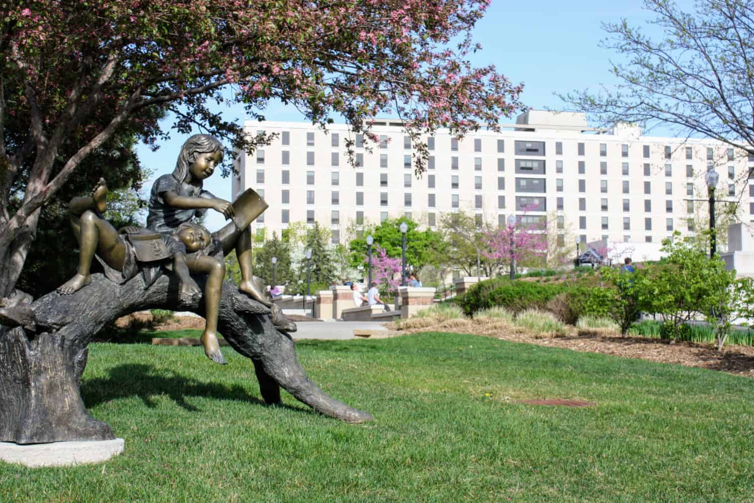 Children reading statue on the Creighton University campus in spring