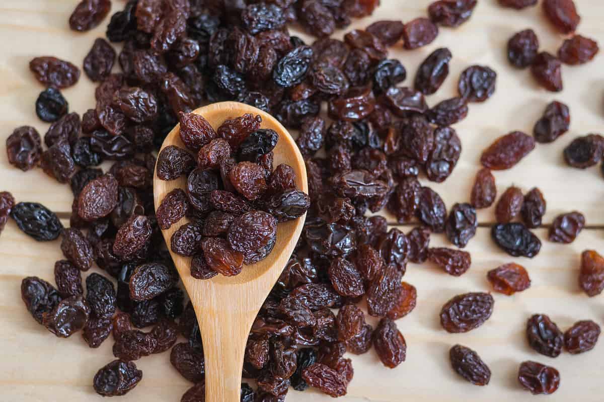 Raisins in a wooden spoon