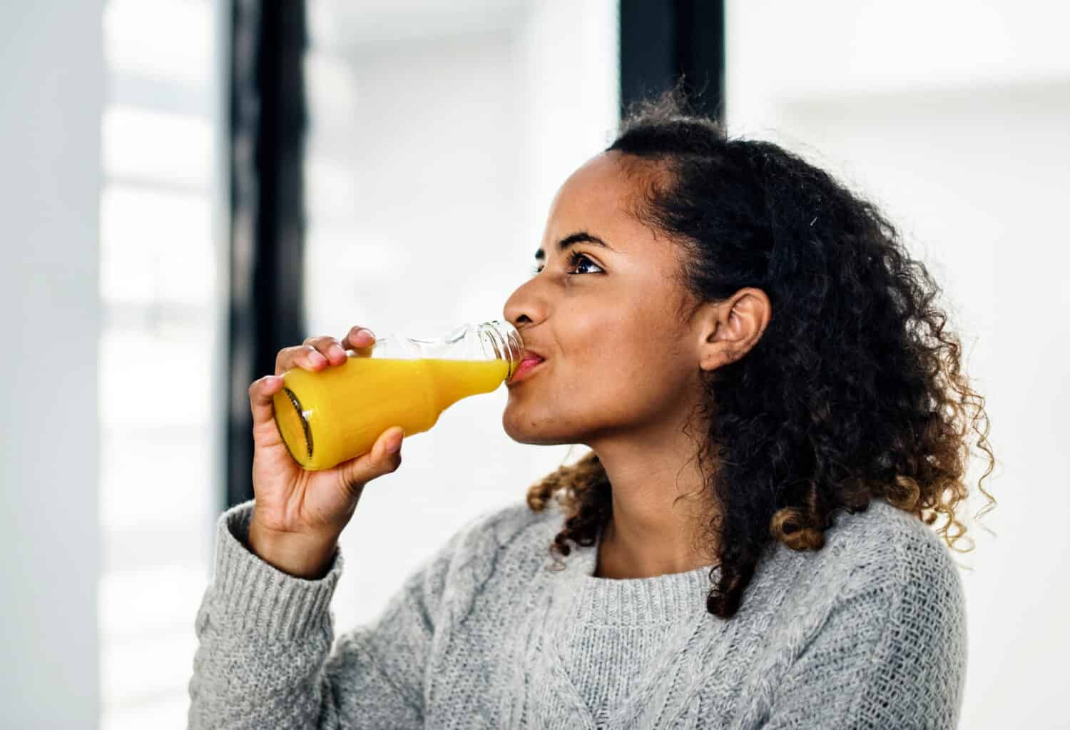 Woman drinking fresh orange juice