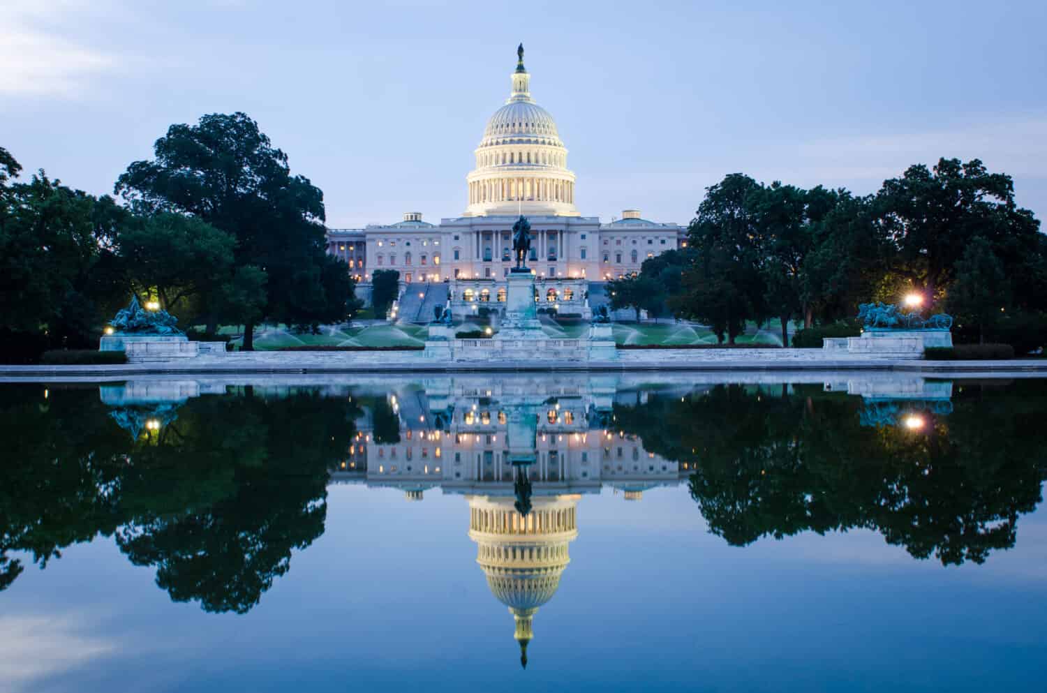 Washington DC, US Capitol Building in a cloudy sunrise with mirror reflection