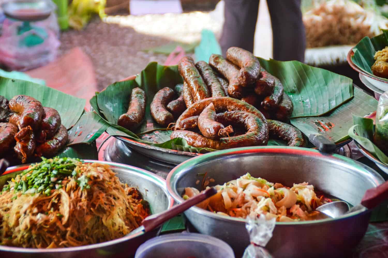 Street foods on the famous morning market in Luang Prabang. Sai oua, Lao grilled pork sausage. Sai kok, chunky Lao pork sausage.