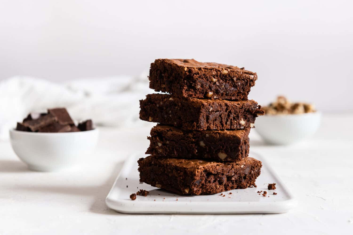 A stack of chocolate brownies on white background, homemade bakery and dessert. Bakery, confectionery concept