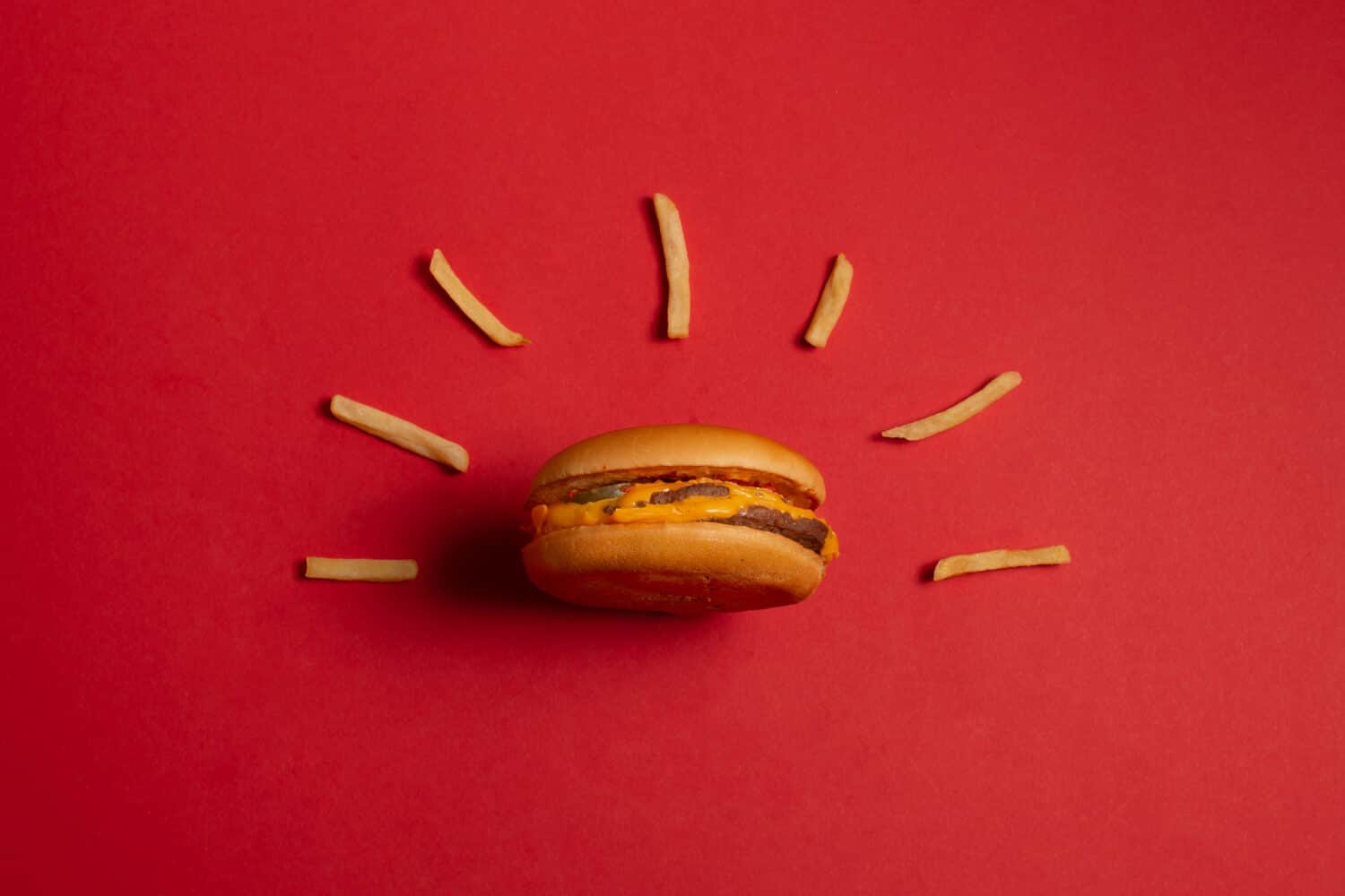 McDonald's menu: French fries and burger on red background. Minimal concept