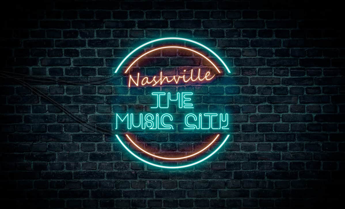 A red and blue neon light sign that reads: Nashville the Music City